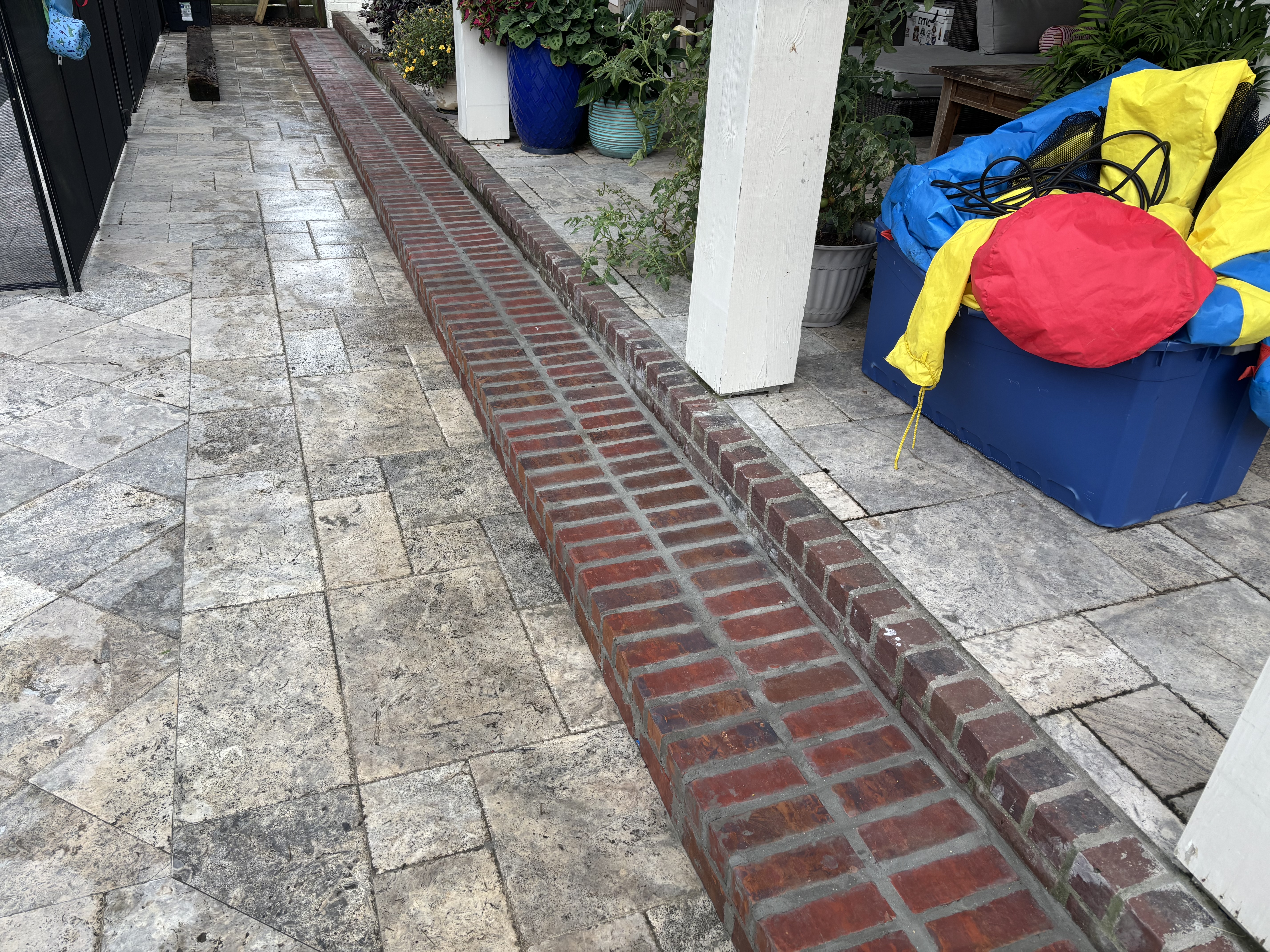 After - custom mortared brick step with rowlock edge installed along travertine walkway in Baton Rouge