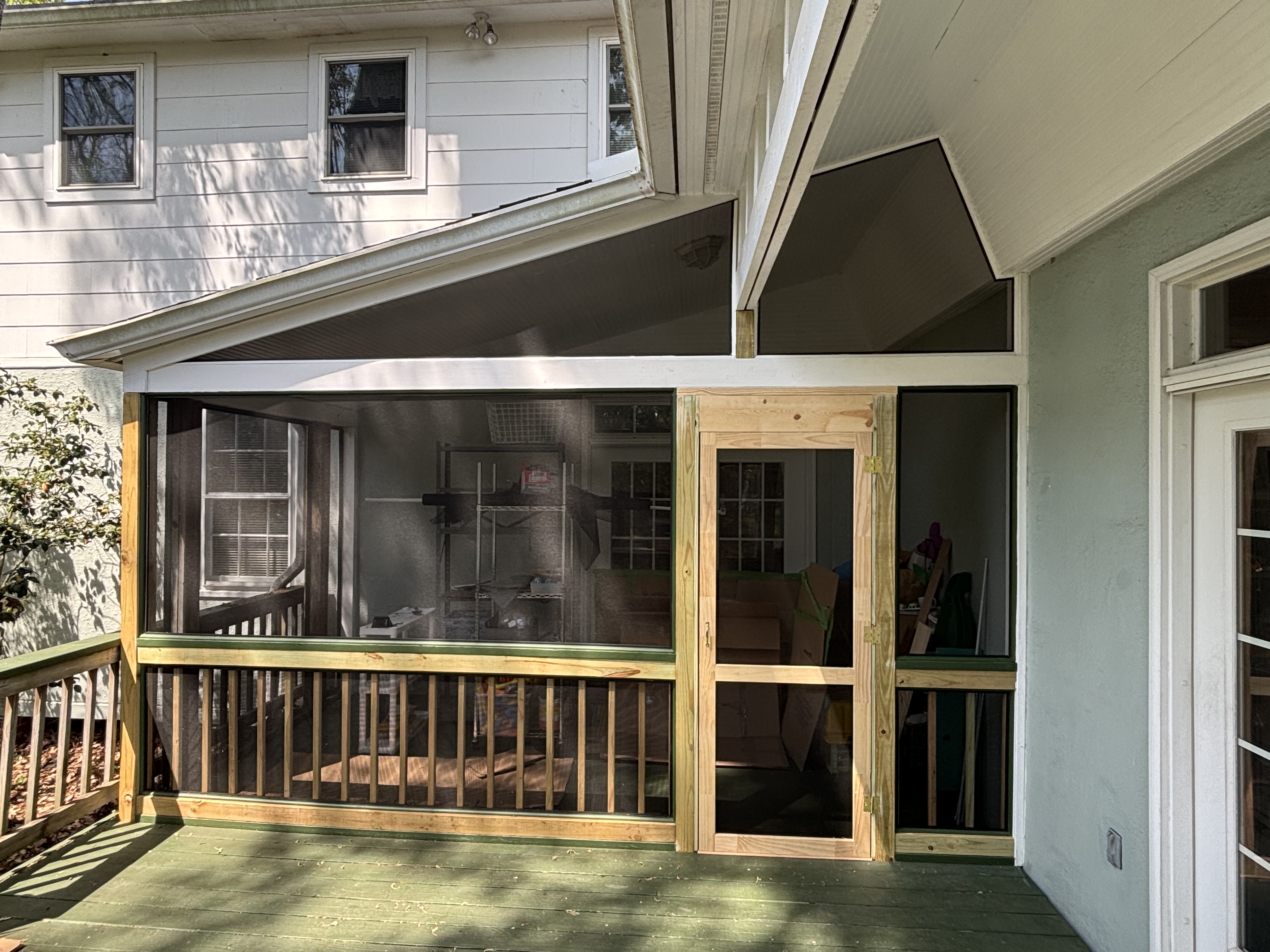 After - screened-in porch with pressure treated framing and screen door