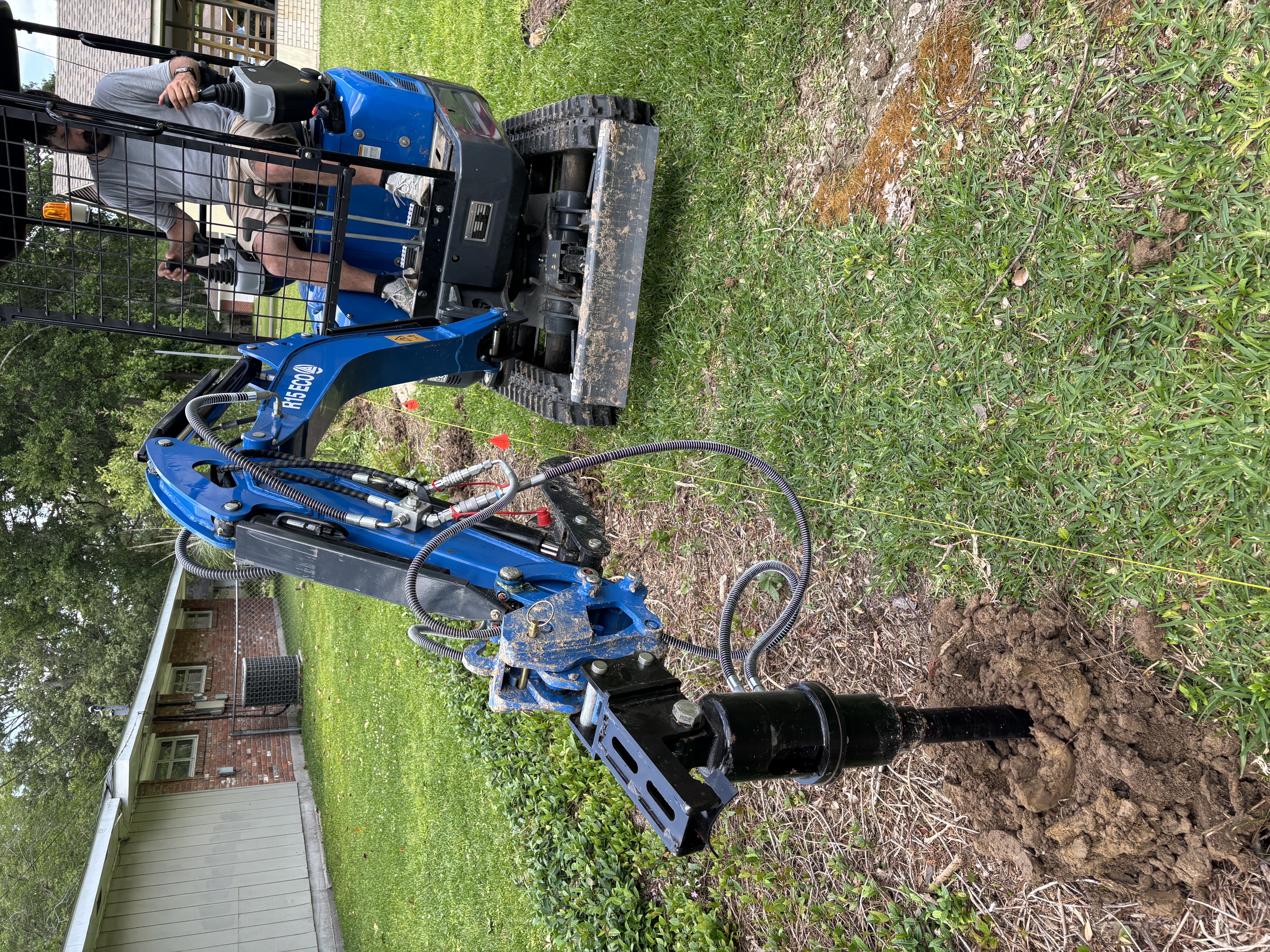 Rippa R15 mini excavator with auger attachment drilling fence post holes - Baton Rouge contractor