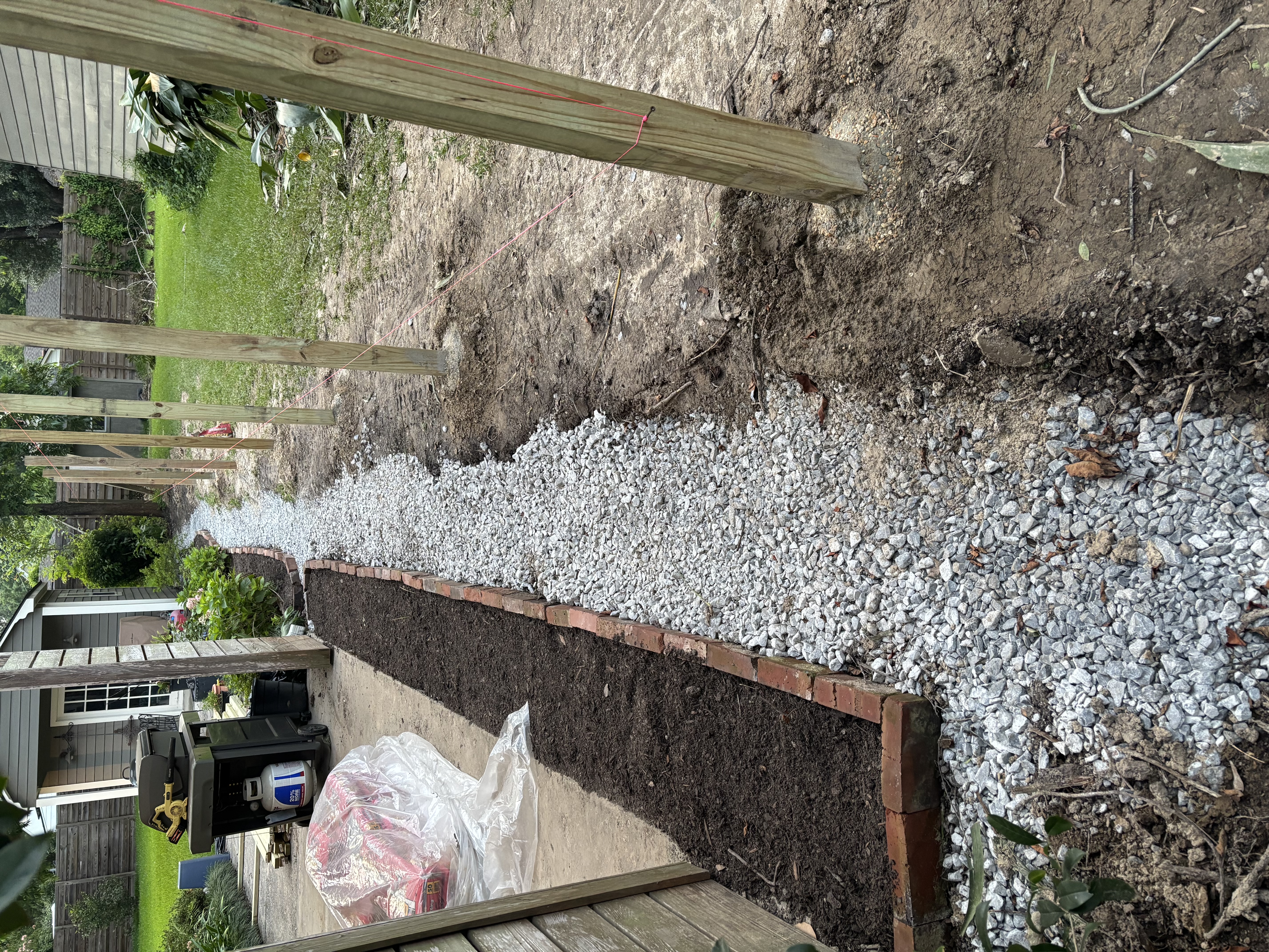 French drain gravel path with brick border and cedar fence posts - Baton Rouge