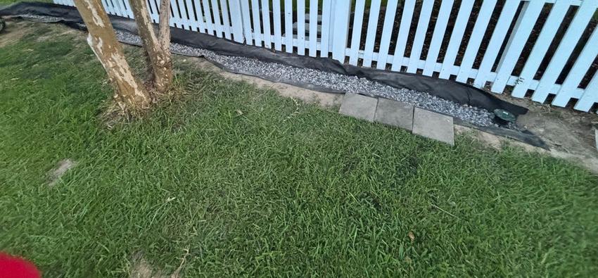 French drain detail with sod and white fence - Baton Rouge drainage