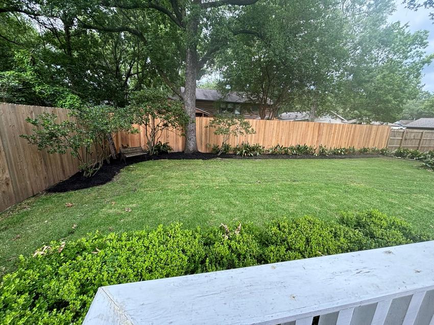 Finished Baton Rouge backyard with cedar fence, sod, and landscape beds by Scag Scapes