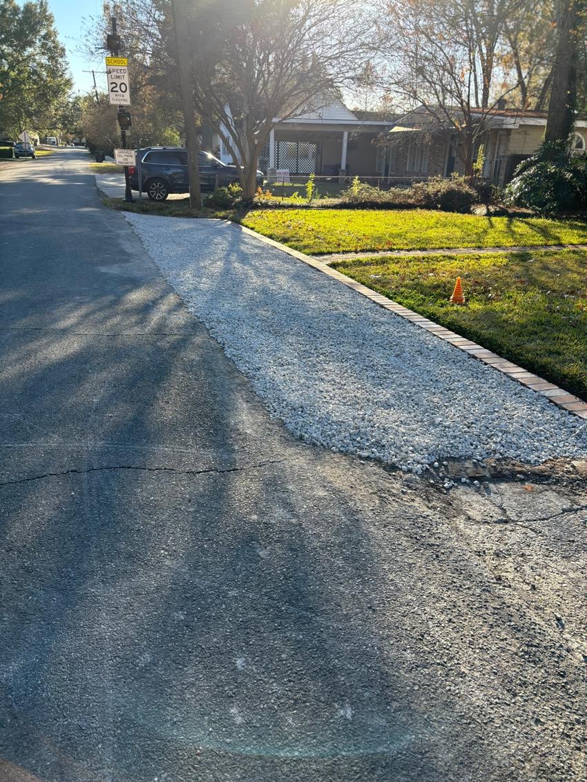 Gravel parking pad with brick border installed in Baton Rouge